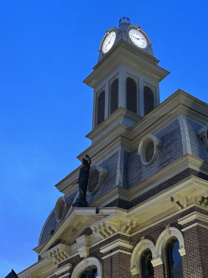 A historic clock tower against a clear blue sky.
